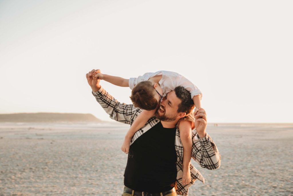 father and son sharing a sweet moment on a beach in cape town