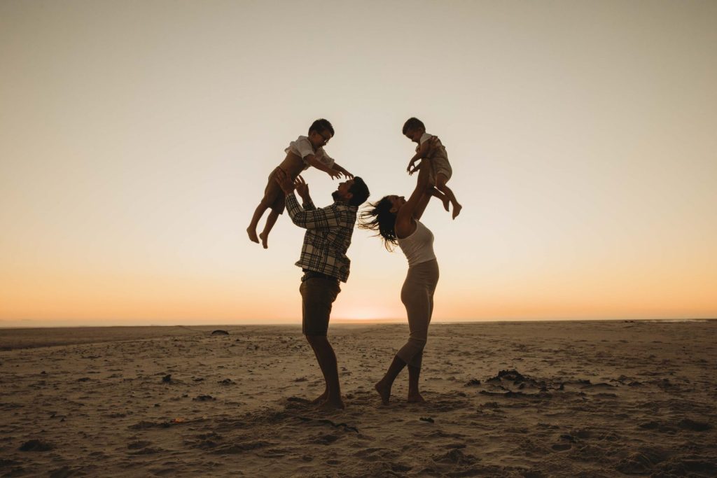 family silhouette on Noordhoek beach during a photo shoot in cape town