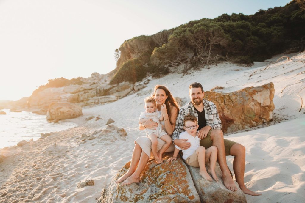 family giggling and laughing together during golden hour 