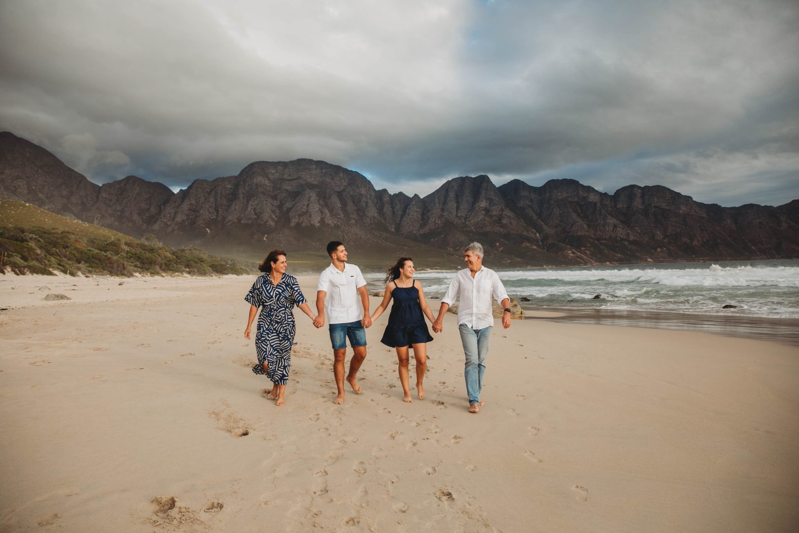 family walking on koelbaai beach for a family shoot in cape town
