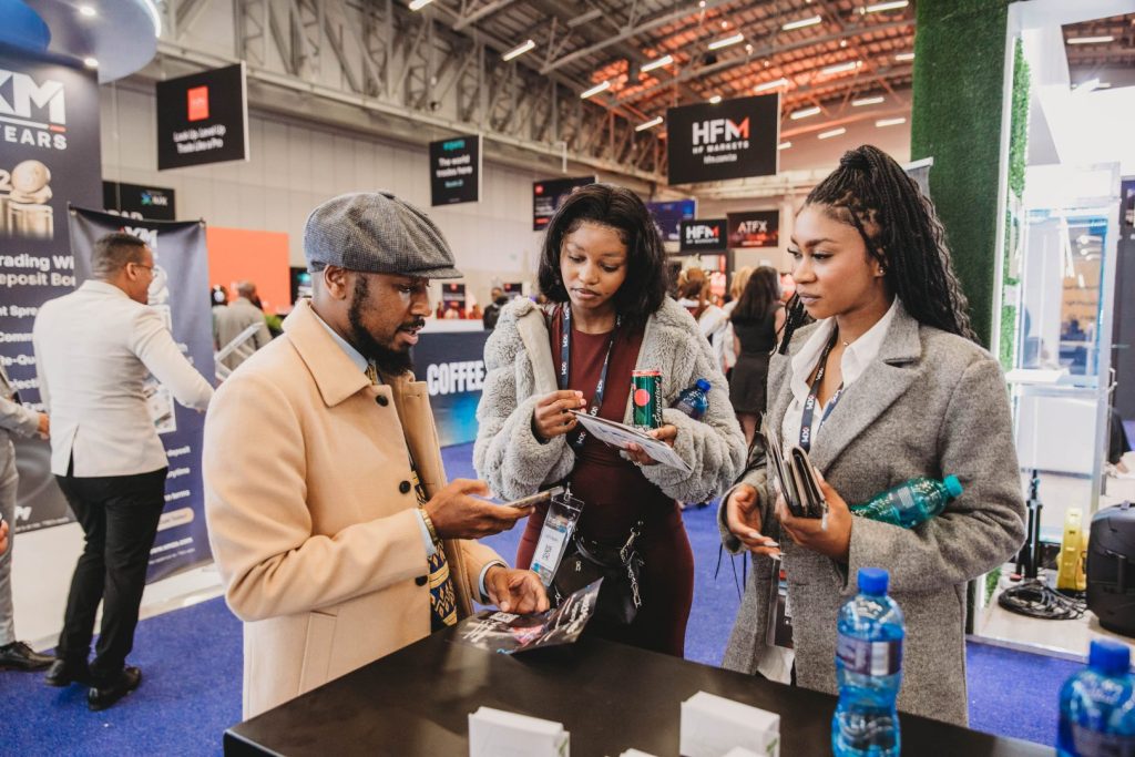 Client learning about investment opportunities at Just Markets stand in Cape Town