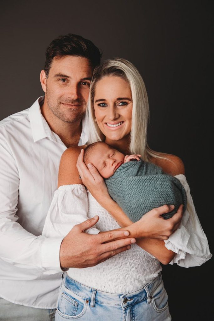 Studio portrait of a newborn baby held by parents, posed family image taken in Cape Town