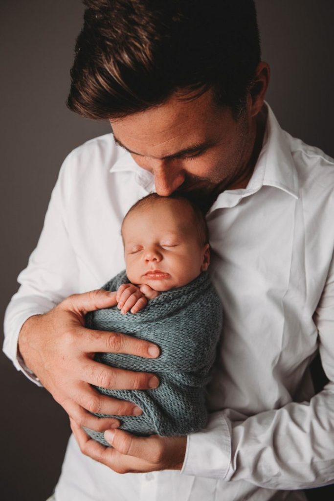 Studio portrait of a newborn baby held by parents, posed family image taken in Cape Town