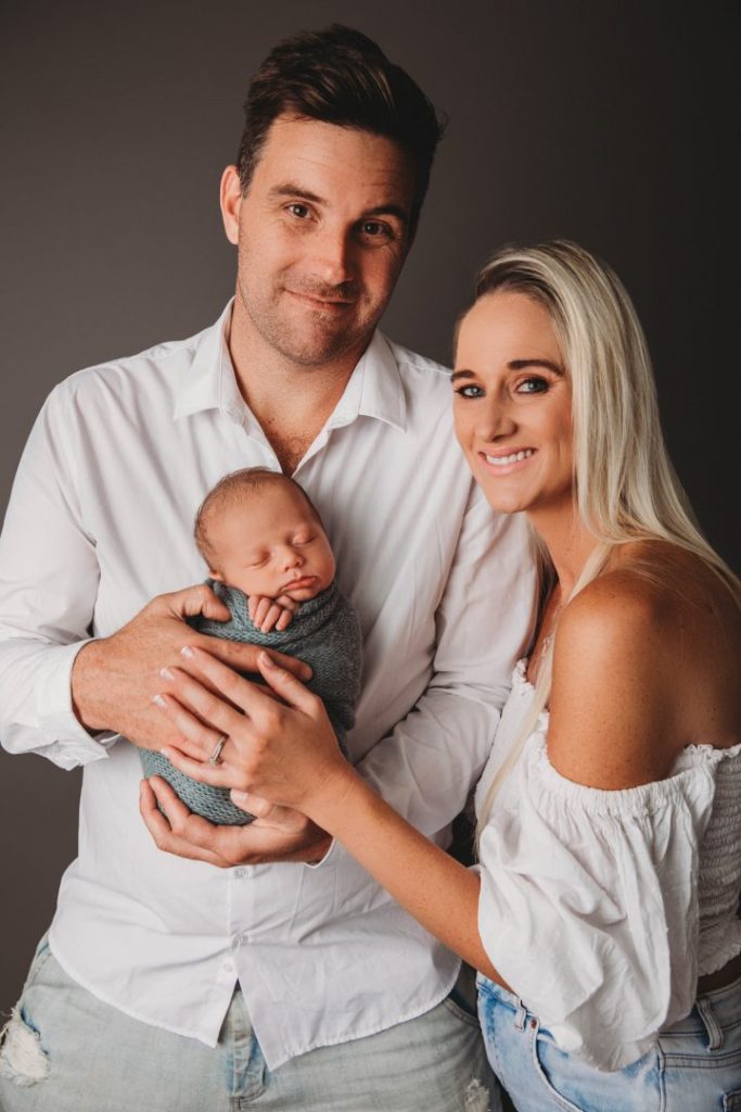 Studio portrait of a newborn baby held by parents, posed family image taken in Cape Town