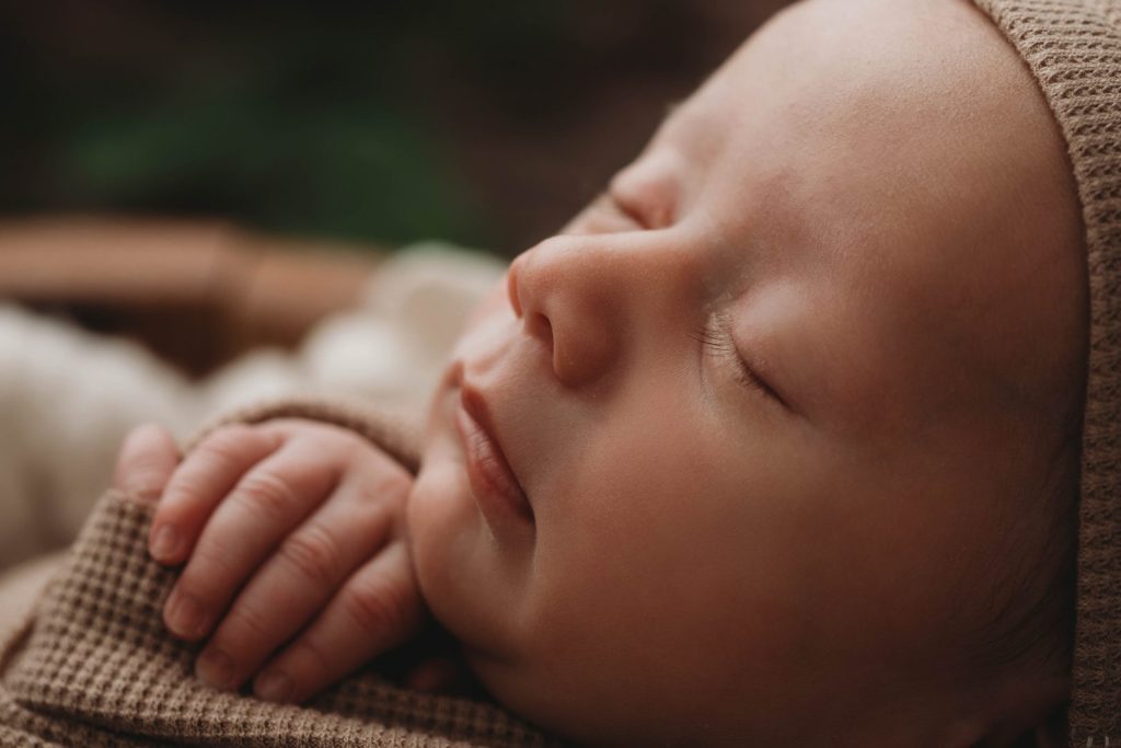 Close-up photo of a newborn baby’s face in a posed studio setup, Cape Town photographer