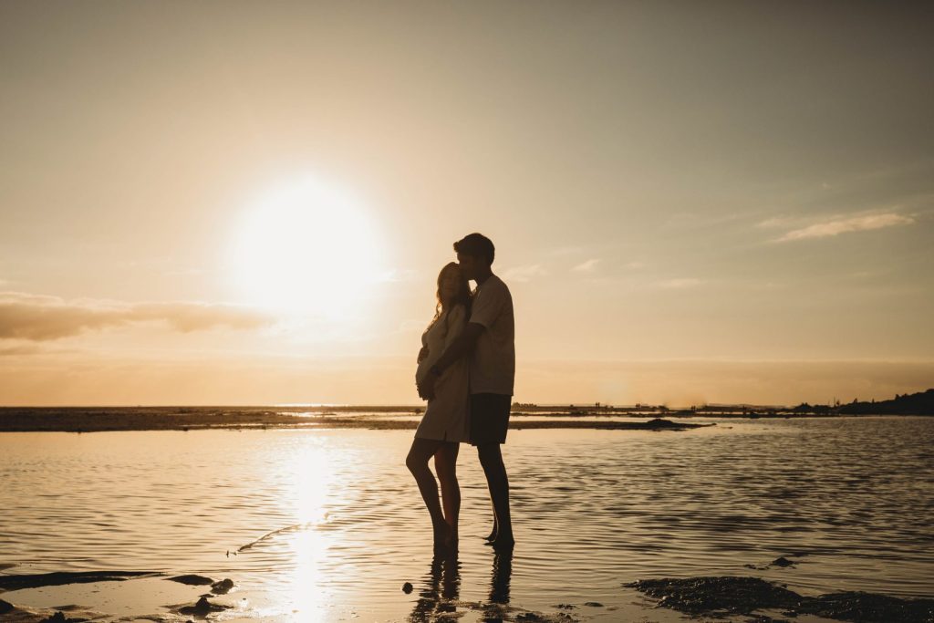 Silhouette of pregnant woman on Noordhoek Beach at sunset