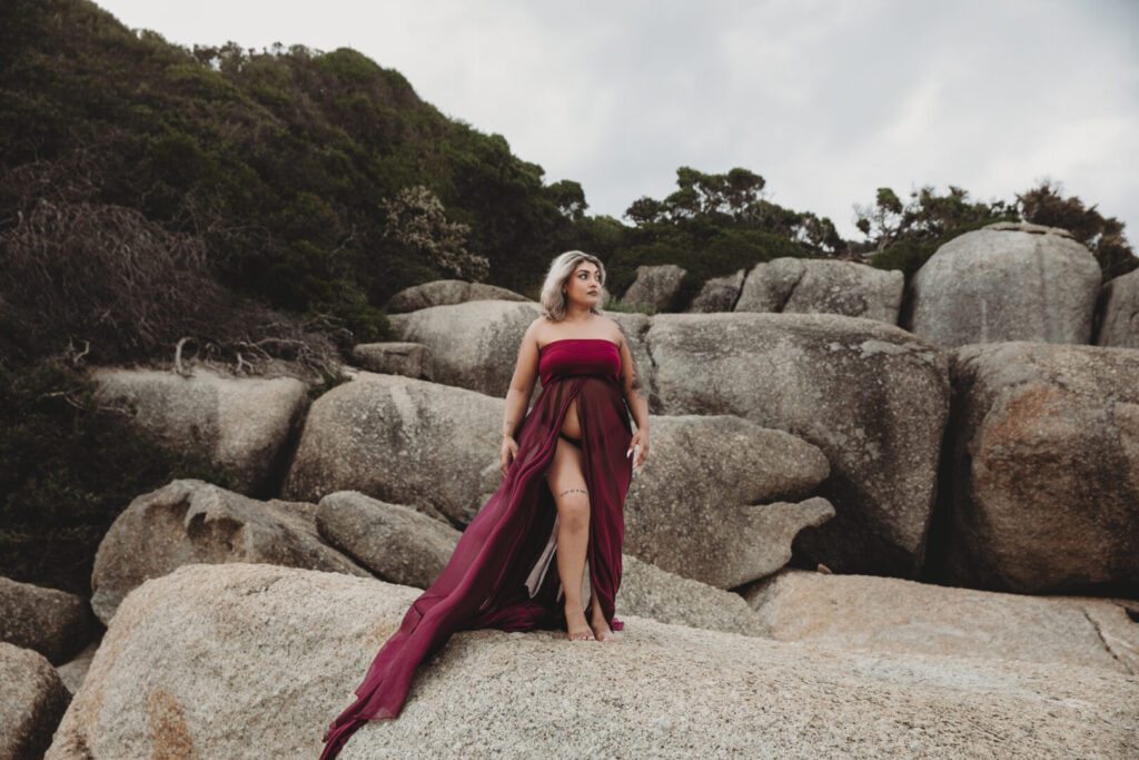 Llandudno Beach maternity photoshoot in Cape Town featuring an expectant mother in a purple dress
