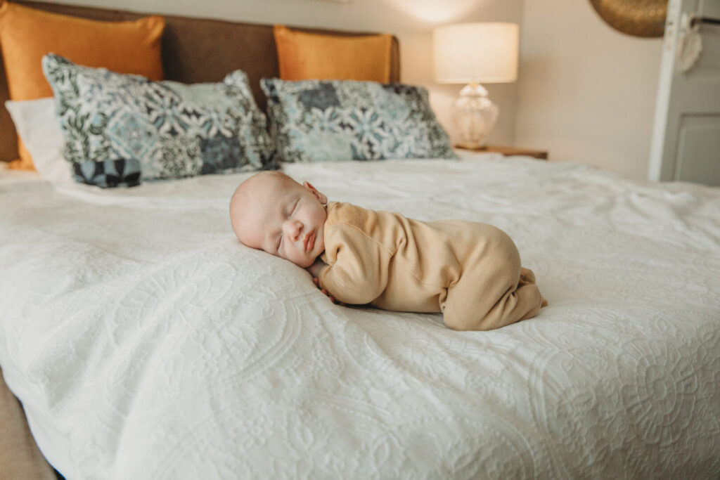 Newborn baby cuddled by mom and dad during lifestyle photoshoot in Cape Town