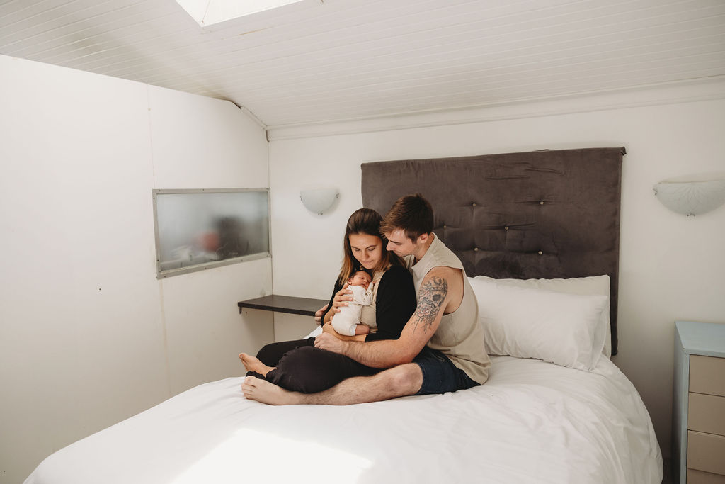 newborn baby with mom and dad at a photo shoot