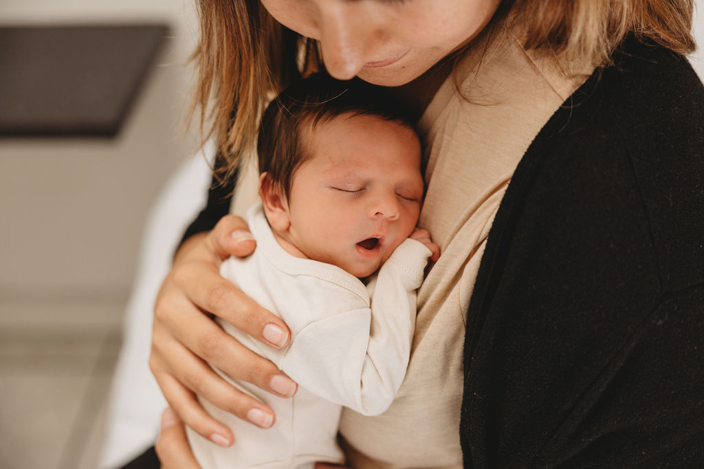 baby sleeping in moms arms in cape tow 