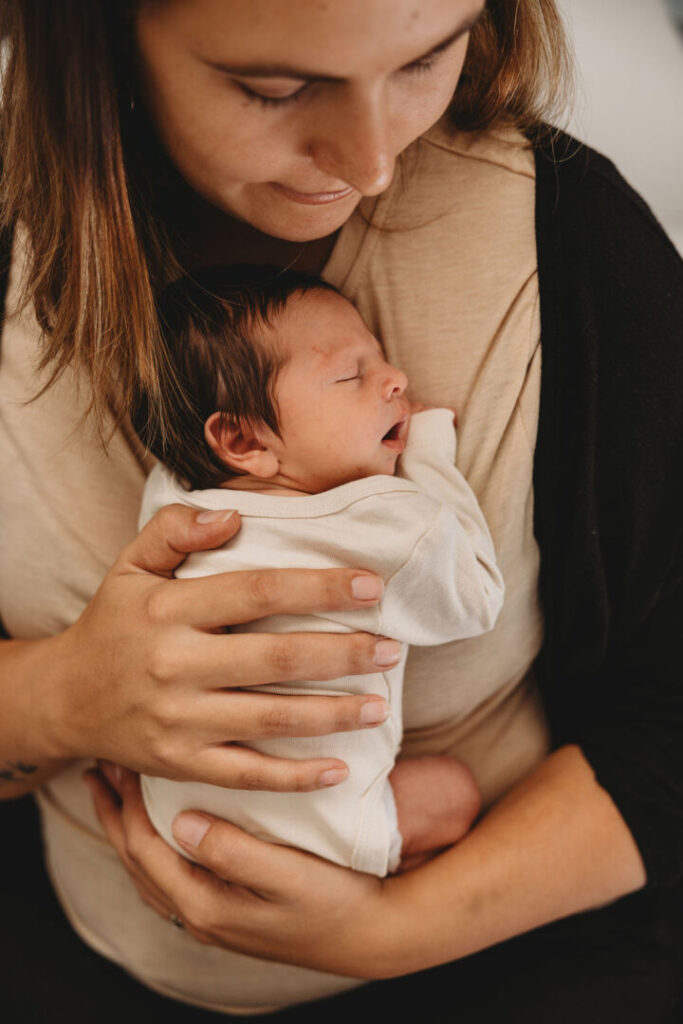 baby sleeping in moms arms in cape tow 
